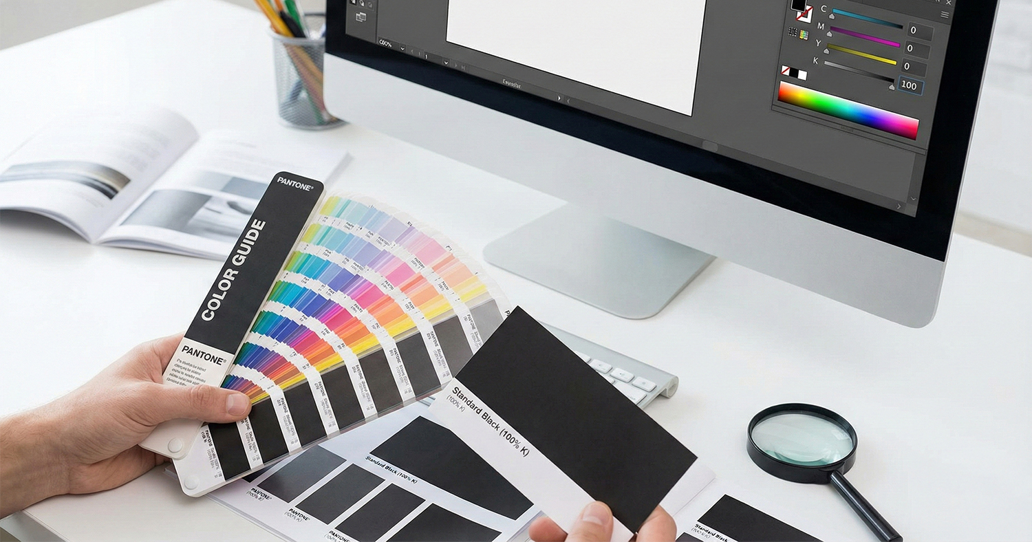 A guy comparing Rich Black vs. Standard Black on a color guide book