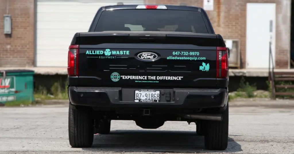 Rear view of a Ford F-150 presented with Allied Waste Equipment decals