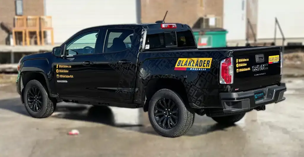 Side view of GMC Canyon partial wrap in matte black with glossy decals by BrandingCentres