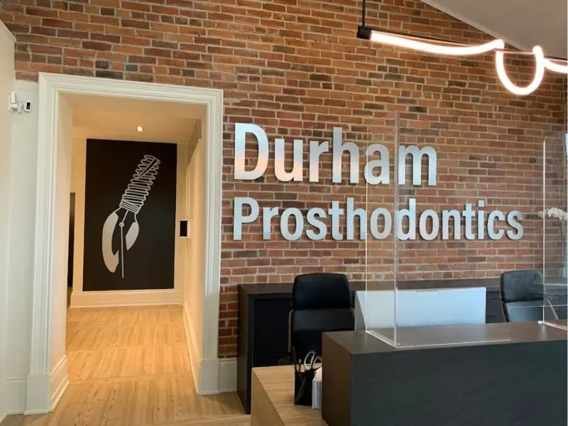 Durham prosthodontics 3d wall sign with the back wall decor at a larger angle.