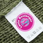 small round pink label on t shirt tag