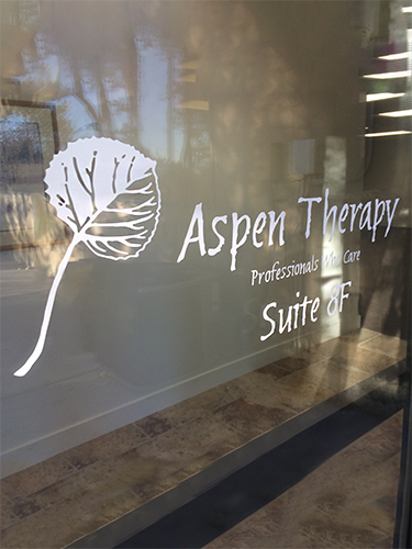 Window to an office showing graphic leaf and name of company