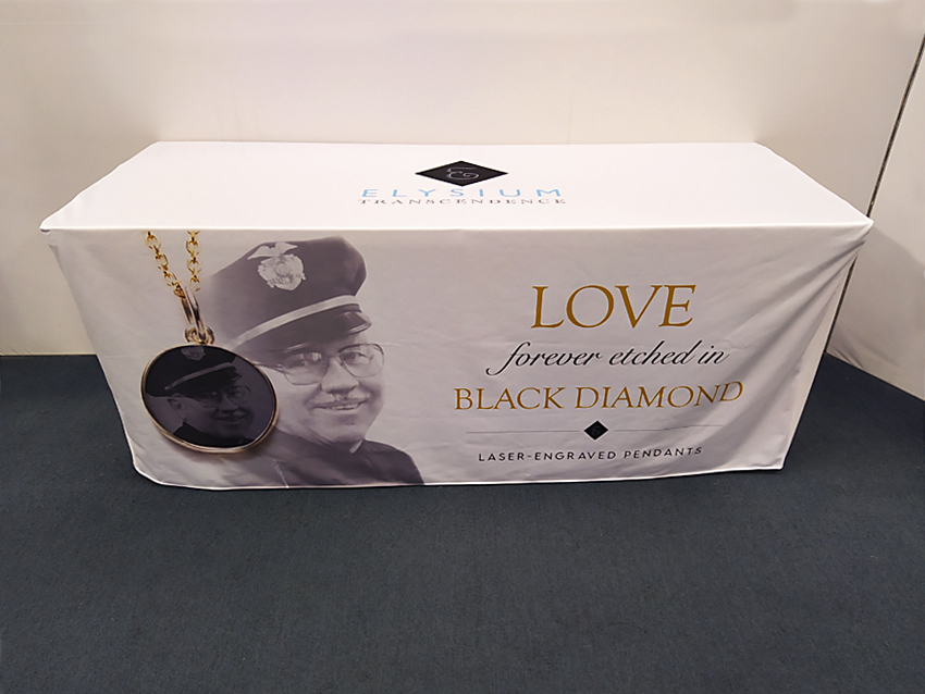 White table throw with Elysium company logo centered on top and front side.