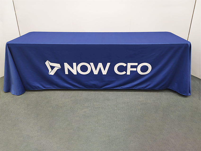 Blue table throw with white NOW CFO company logo centered on front side.
