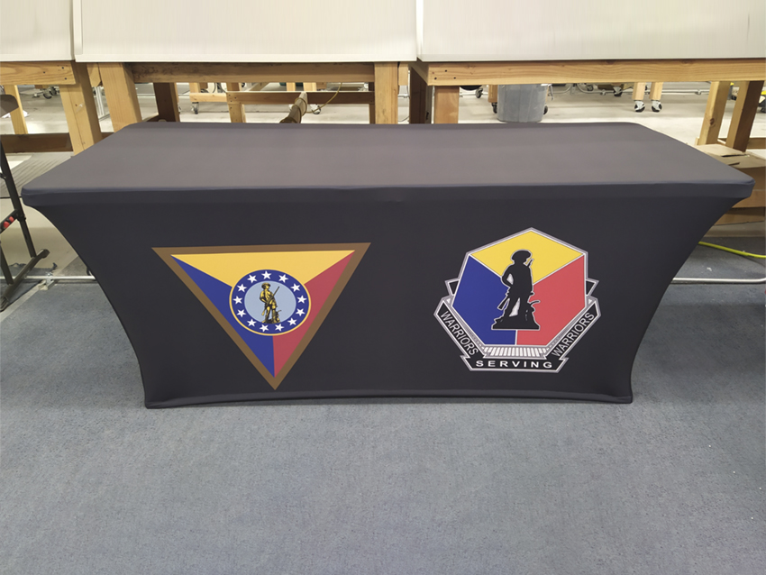 Fitted black tablecloth showing teo different Warriors Serving Warriors logos.