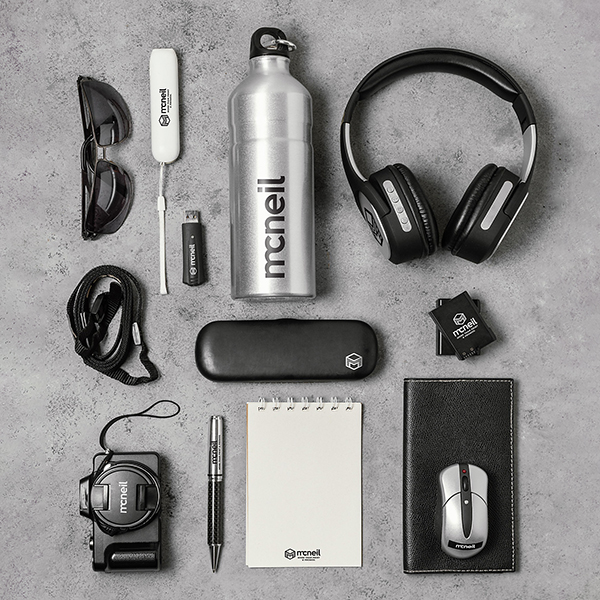 Photograph showing various technical items, such as headphones, earbuds, flash drives, etc.