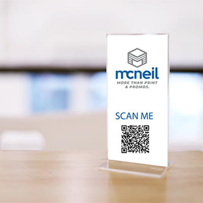 Photograph showing close up an acrylic table stand with company logo insert.