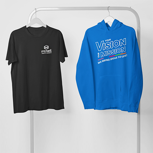 Black Tshirt and bright blue sweatshirt, with McNeil's branded logo, on both. They are hanging on a display clothing rack.