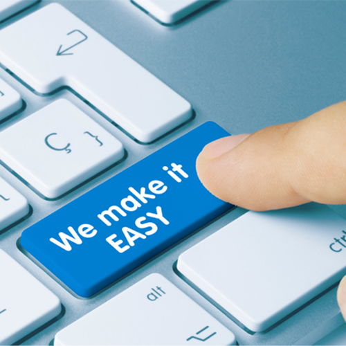 A photograph a keyboard shoing a finger pressing the key: We Make It EASY.