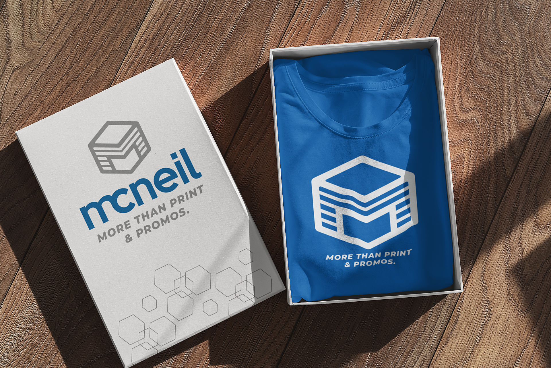 Picture showing McNeil Printing box with McNeil Printing T-shirt inside.
