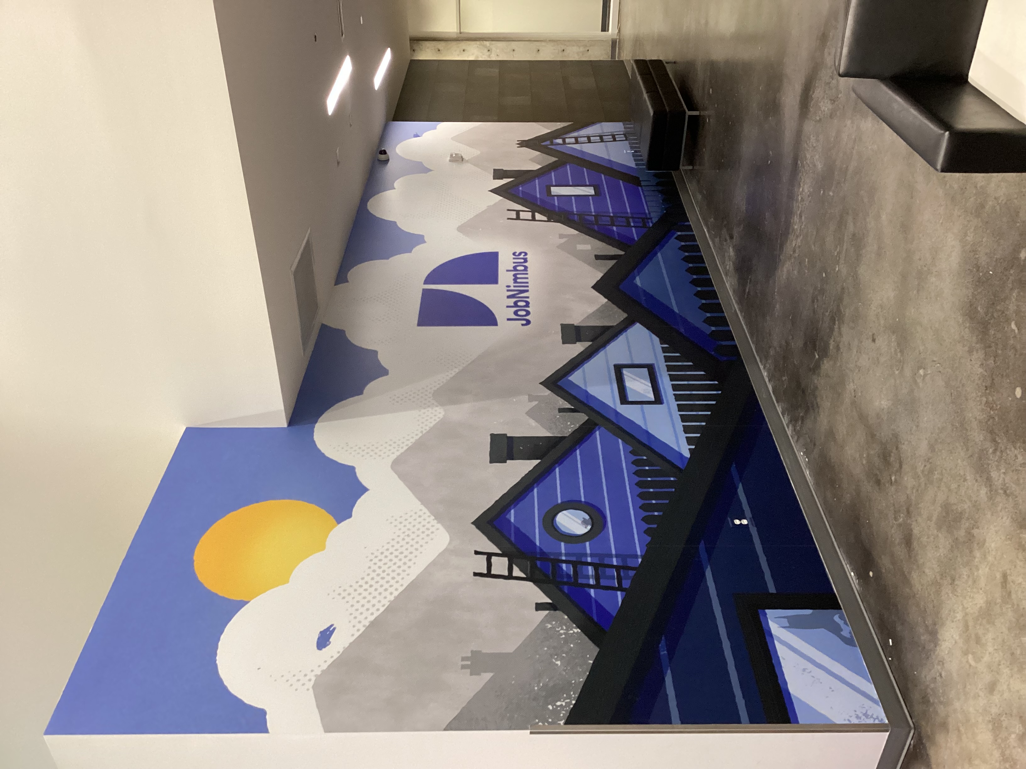 wall mural of a company logo and the tops of houses