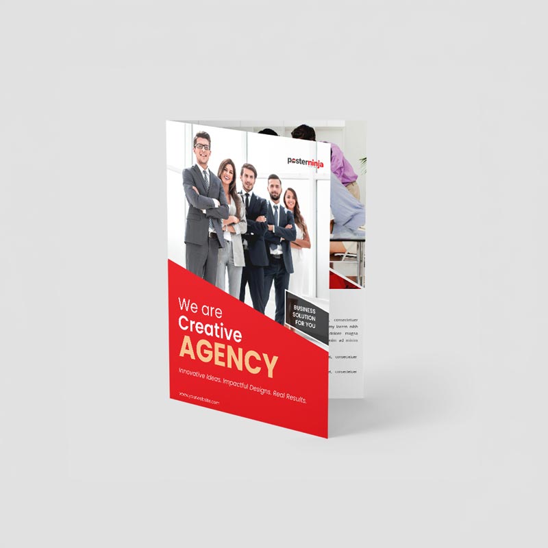 Compact custom half-fold brochure shown standing upright with red agency artwork.