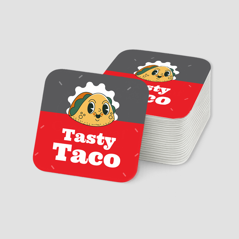 Rounded Corner Stickers Stack of custom printed square vinyl stickers with smooth rounded corners featuring a 'Tasty Taco' food logo.