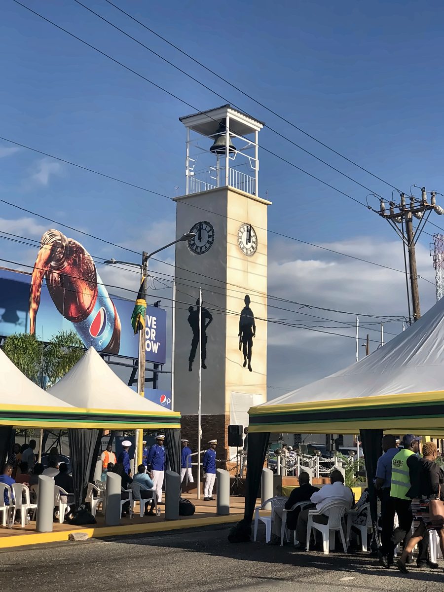 Custom clock tower with event tents in a public square