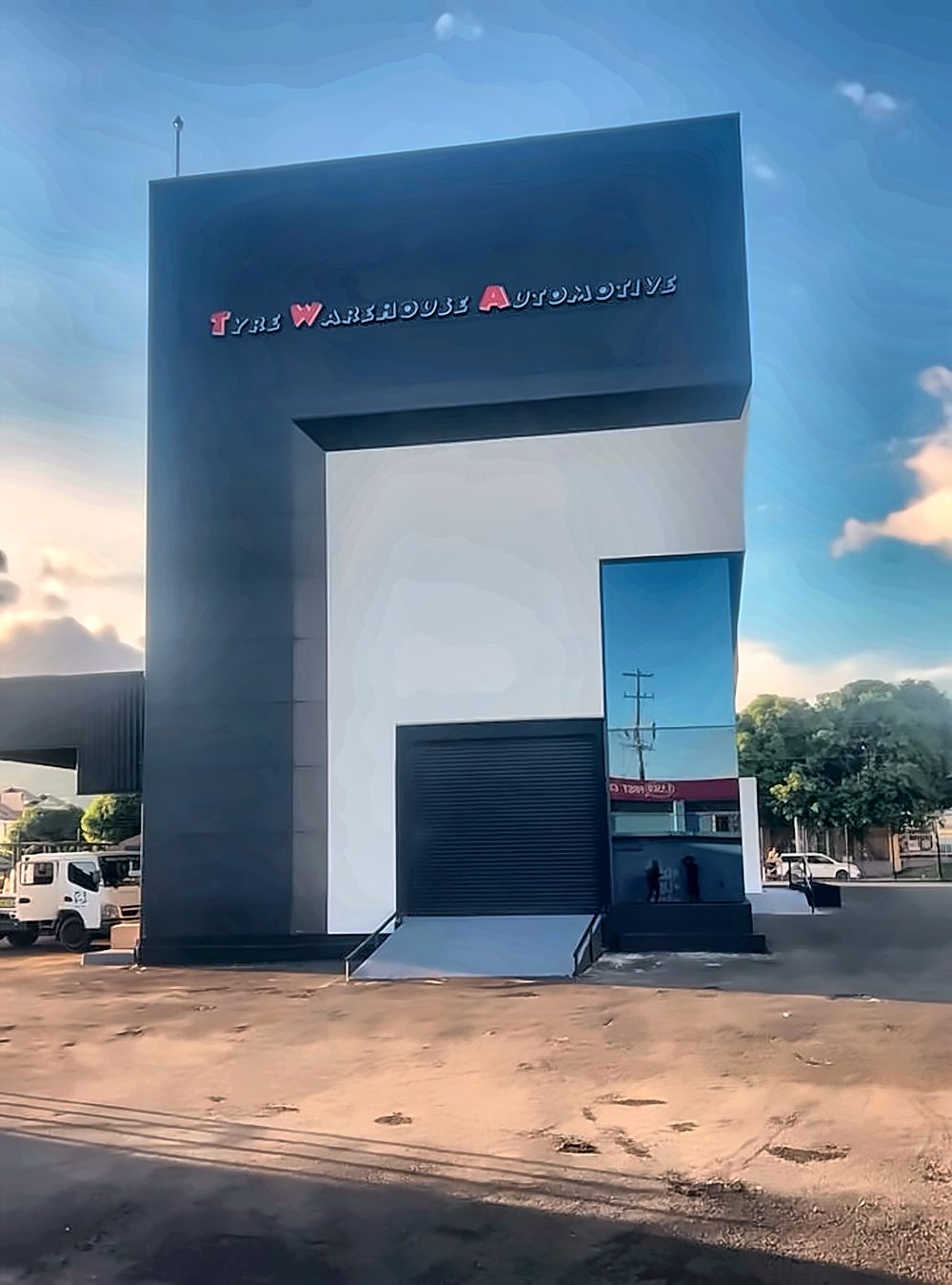 Tyre Warehouse Automotive building identification lettering on the entrance tower
