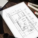 Blueprint with house plans on a table with tools
